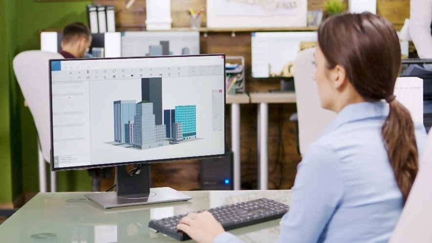 Femme travaillant sur un logiciel de modélisation 3D pour la conception de bâtiments.